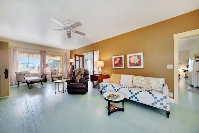 a bedroom with a bed and large windows