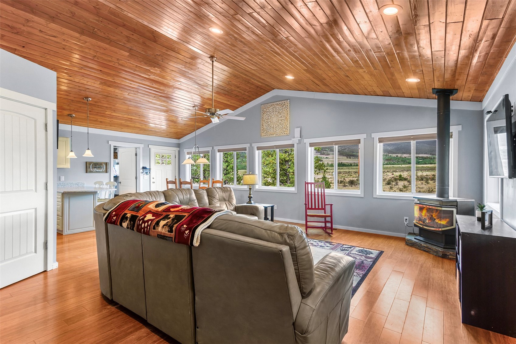 485 High Creek Road Fairplay, CO 80440 - Photo 5 of 32 Living area featuring a wood stove, wooden ceiling, a ceiling fan, lofted ceiling, and recessed lighting
