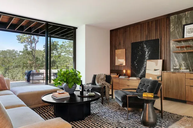 a view of a house with a yard and a large tree