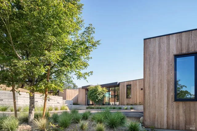 a view of a patio with a table and chairs under an umbrella