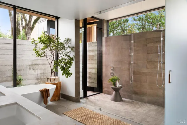 a white bath tub sitting in front of a window