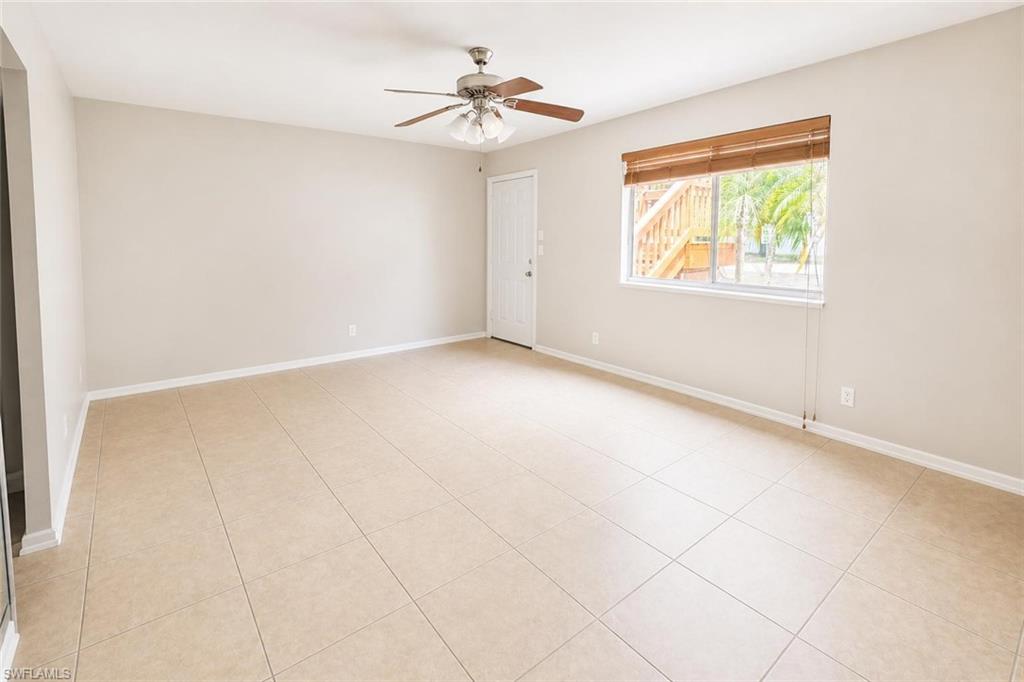 5410 16th Place Southwest, Unit B1 Naples, FL 34116 - Photo 12 of 26 an empty room with windows and fan