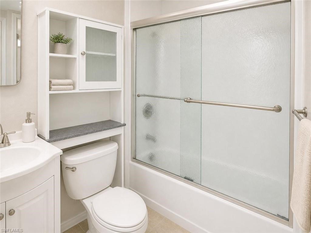 5410 16th Place Southwest, Unit B1 Naples, FL 34116 - Photo 16 of 26 a white toilet sitting next to a bathroom sink