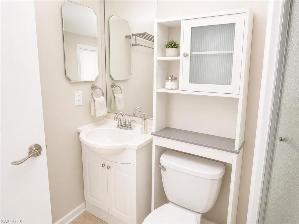 5410 16th Place Southwest, Unit B1 Naples, FL 34116 - Photo 17 of 26 a bathroom with a toilet sink and mirror