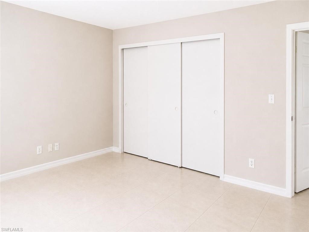 5410 16th Place Southwest, Unit B1 Naples, FL 34116 - Photo 18 of 26 an empty room with a door