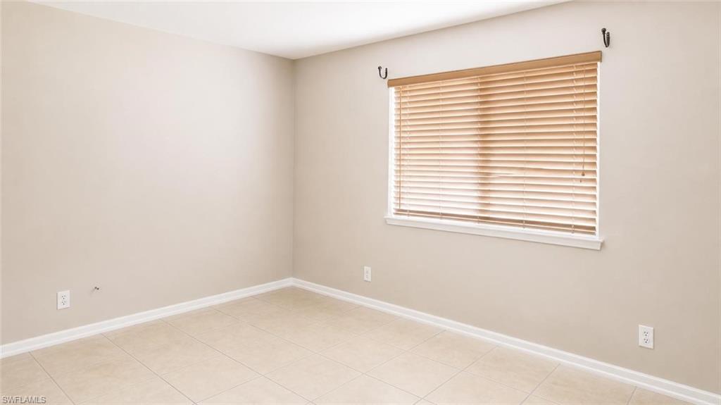 5410 16th Place Southwest, Unit B1 Naples, FL 34116 - Photo 19 of 26 an empty room with a window