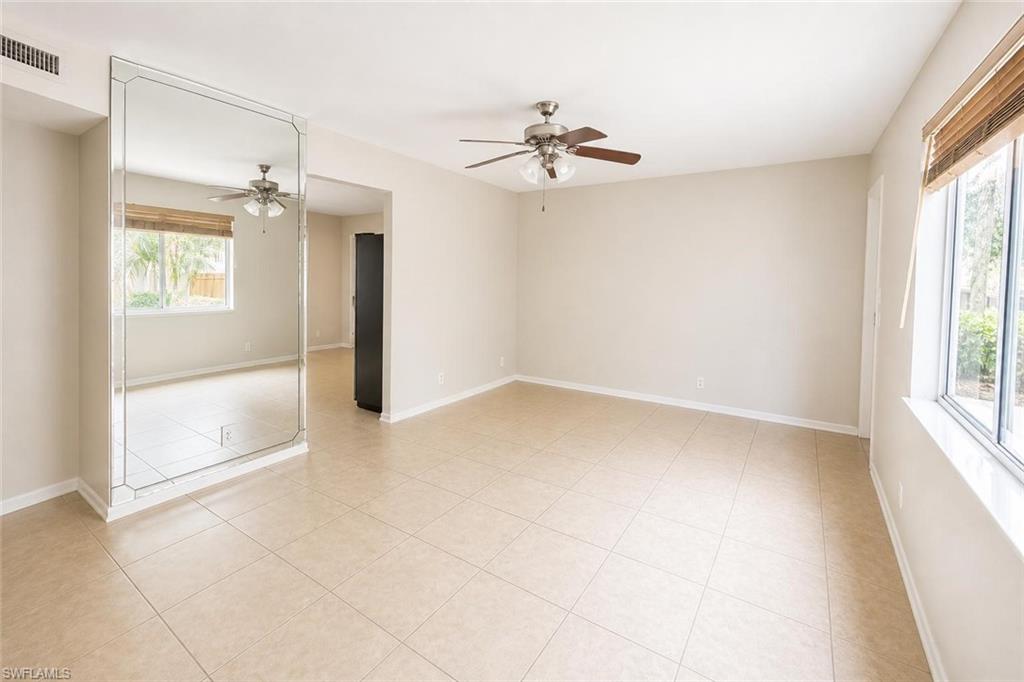 5410 16th Place Southwest, Unit B1 Naples, FL 34116 - Photo 20 of 26 an empty room with windows and fan