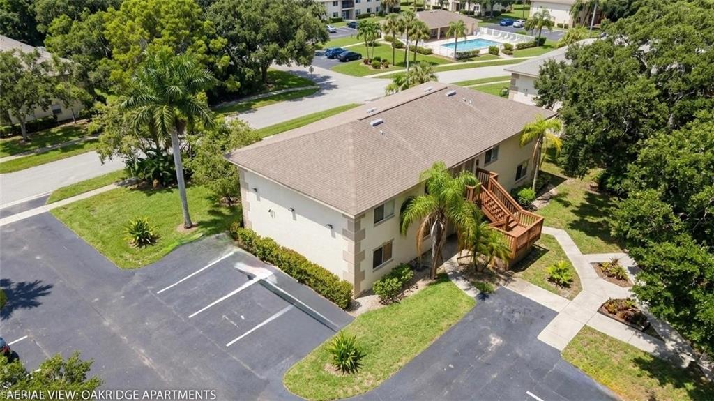 5410 16th Place Southwest, Unit B1 Naples, FL 34116 - Photo 2 of 26 an aerial view of a house with a yard basket ball court and outdoor seating