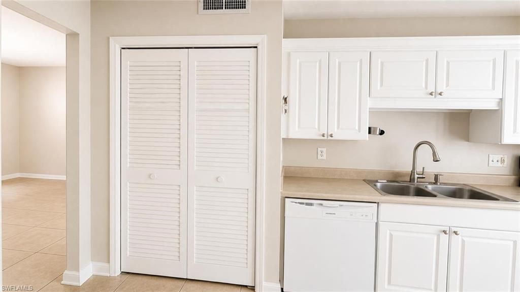 5410 16th Place Southwest, Unit B1 Naples, FL 34116 - Photo 21 of 26 a kitchen with granite countertop white cabinets and sink