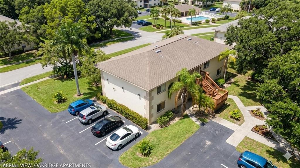 5410 16th Place Southwest, Unit B1 Naples, FL 34116 - Photo 23 of 26 an aerial view of a house with a garden and swimming pool
