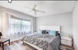 8370 Whispering Oak Way West Palm Beach, FL 33411 - Photo 11 of 14 a bedroom with a large bed and a chandelier