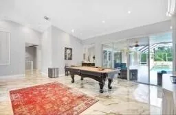a living room with furniture a table and large windows