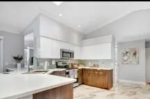 a large kitchen with lots of counter space and stainless steel appliances