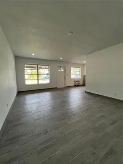 a view of wooden floor and windows in an empty room