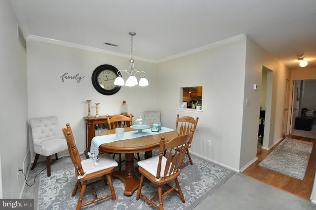 a dining room with furniture and a clock