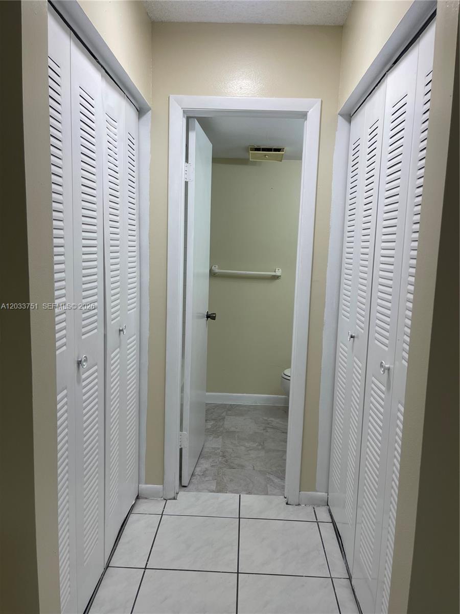 3252 Foxcroft Road, Unit 307 Miramar, FL 33025 - Photo 19 of 41 Closets and hallway to bathroom