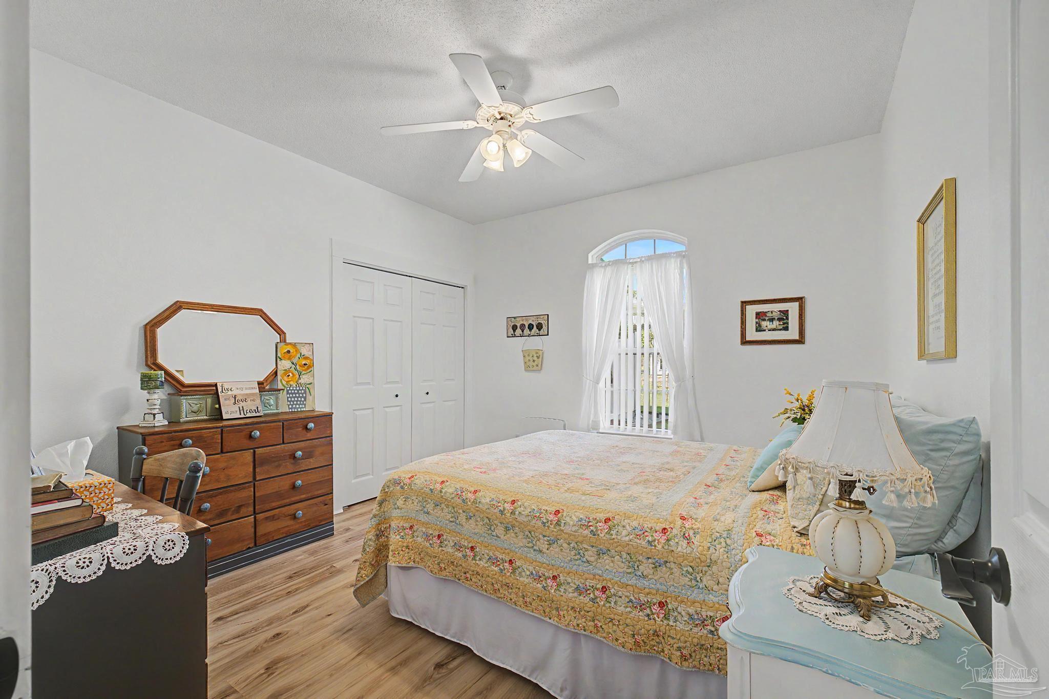 2005 Riviera Lane South Navarre, FL 32566 - Photo 31 of 70 a bedroom with a bed and wooden floor