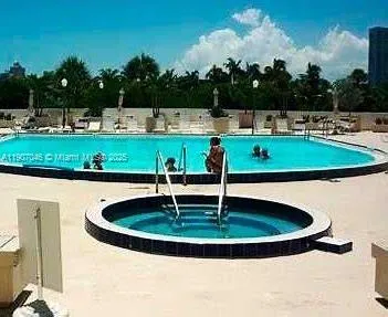 a view of a swimming pool with a yard