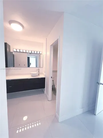a bathroom with a double vanity sink and mirror