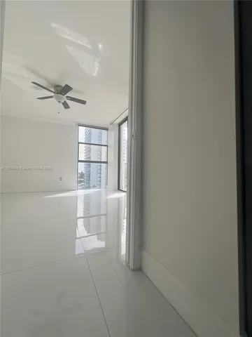 a view of a livingroom with a ceiling fan and window