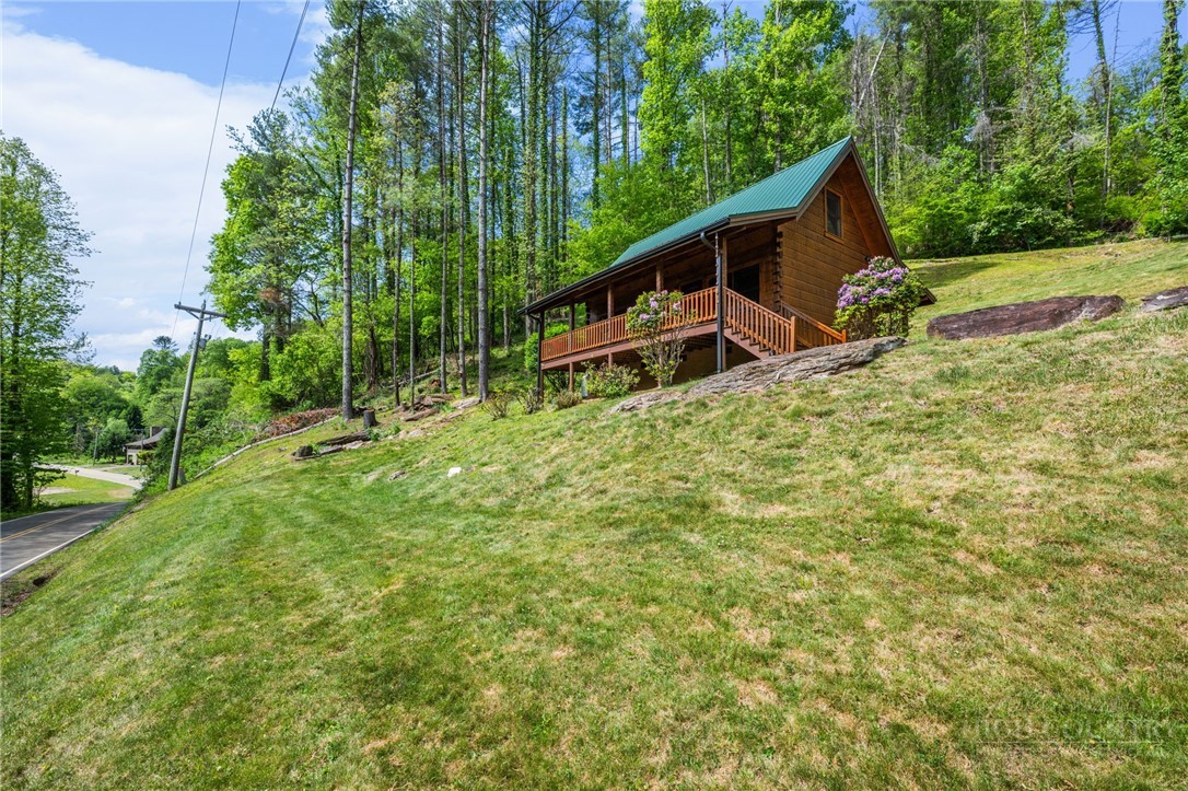 613 Silas Creek Road Lansing, NC 28643 - Photo 5 of 40 a backyard of a house with table and chairs