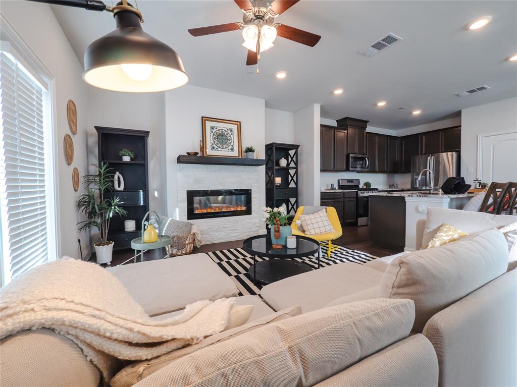 2000 Naples Drive Rowlett, TX 75088 - Photo 1 of 21 a living room with furniture a fireplace and a chandelier