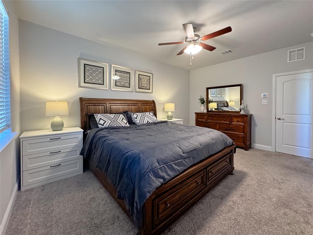 2000 Naples Drive Rowlett, TX 75088 - Photo 14 of 21 a bedroom with a bed and a chandelier