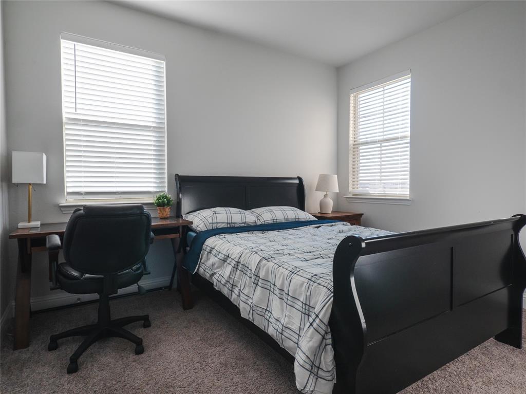 2000 Naples Drive Rowlett, TX 75088 - Photo 17 of 21 a bedroom with a bed and a window