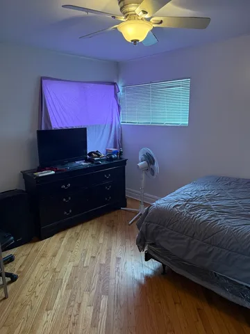 a bedroom with a bed and a desk