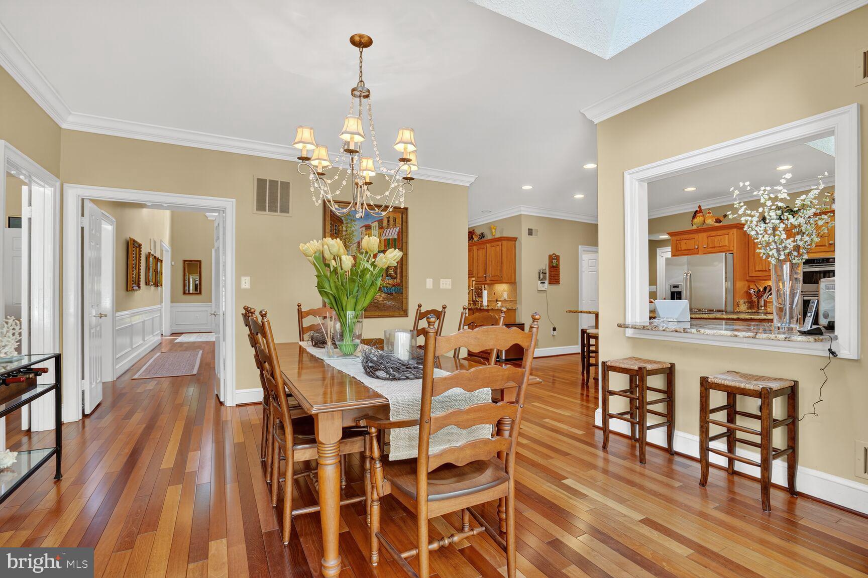 6705 Cedar View Court Clifton, VA 20124 - Photo 16 of 72 a view of a dining room with furniture wooden floor and chandelier