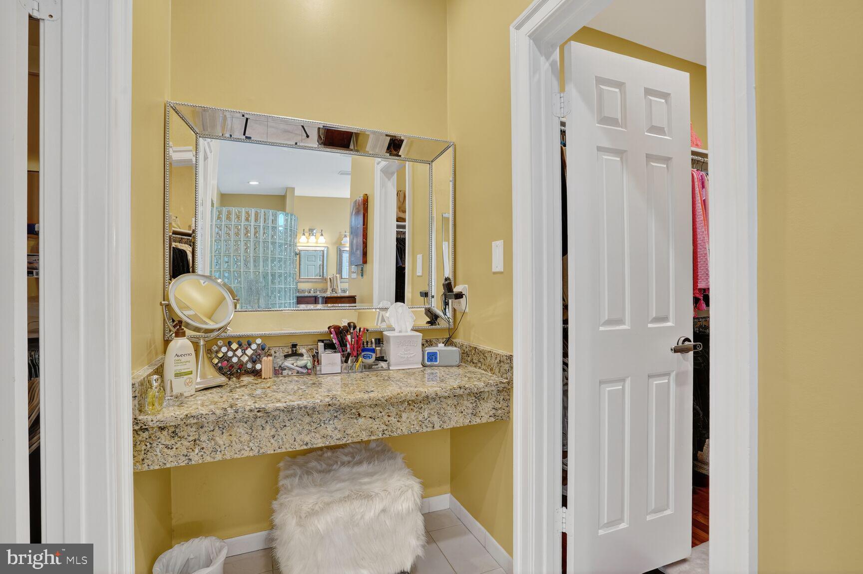 6705 Cedar View Court Clifton, VA 20124 - Photo 34 of 72 a bathroom with a granite countertop sink and a mirror