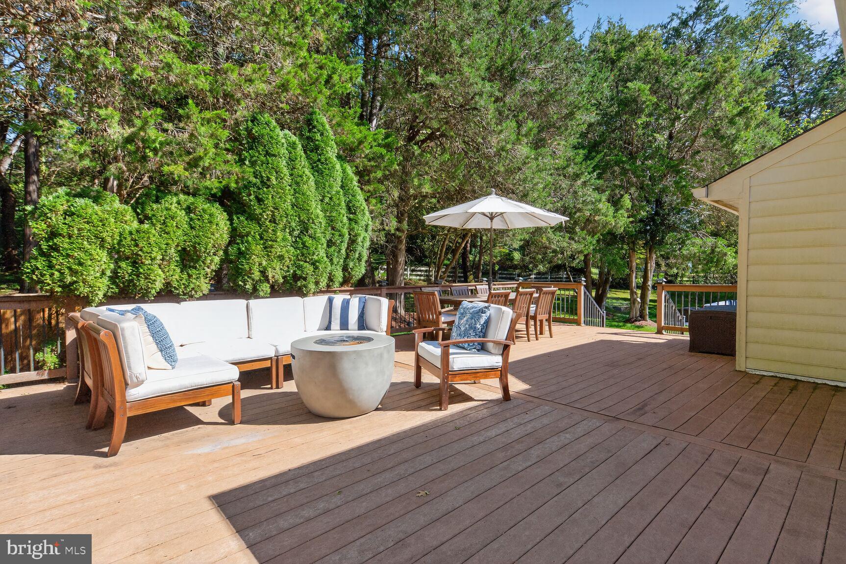 6705 Cedar View Court Clifton, VA 20124 - Photo 45 of 72 an outdoor sitting area with furniture and umbrella