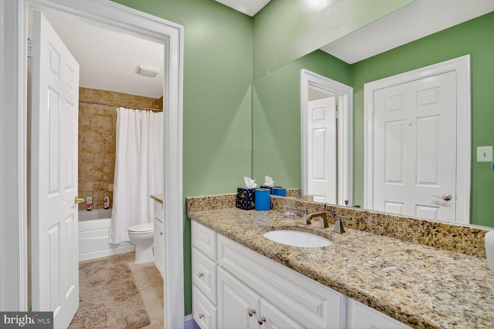 6705 Cedar View Court Clifton, VA 20124 - Photo 51 of 72 a bathroom with a granite countertop sink and a mirror