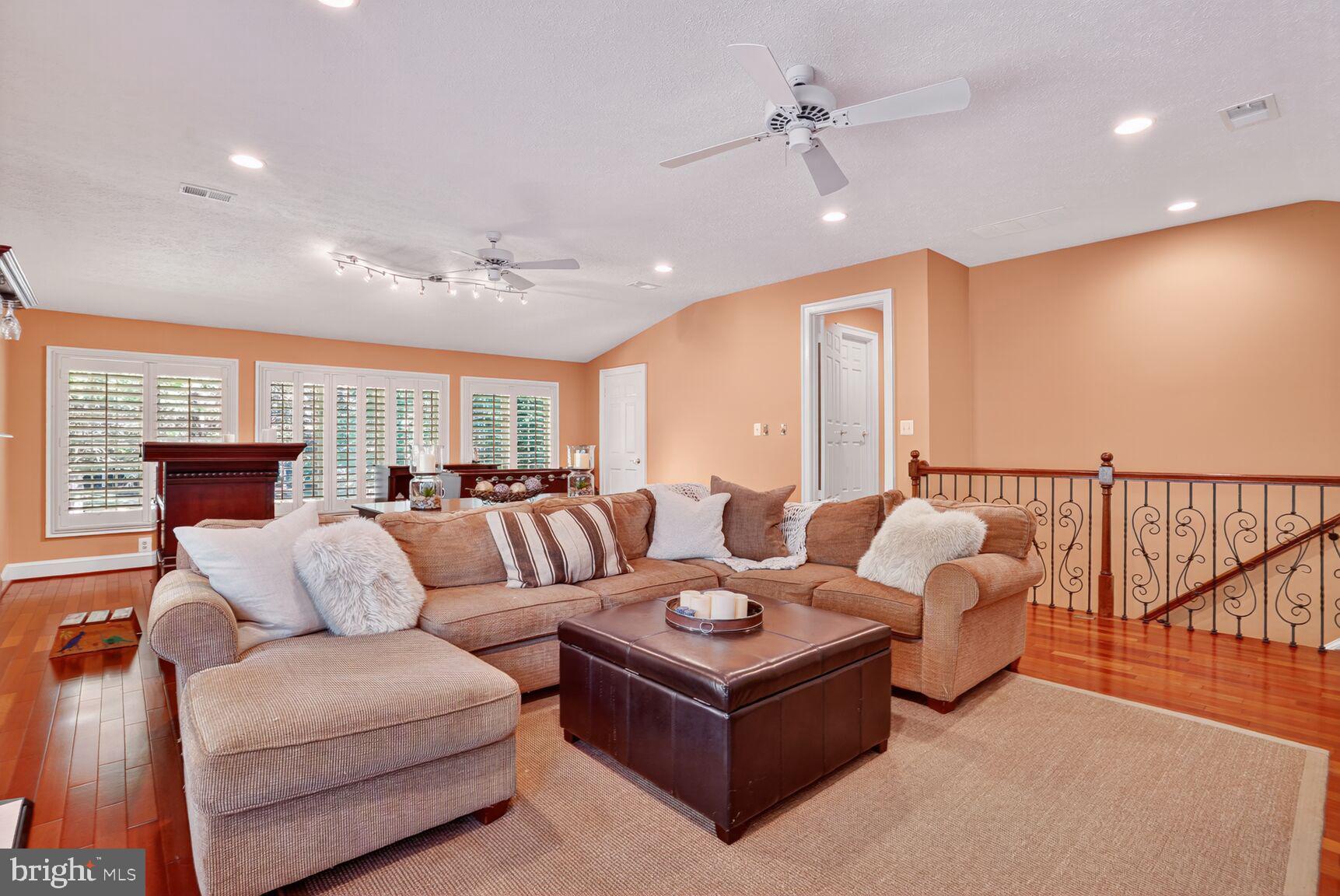 6705 Cedar View Court Clifton, VA 20124 - Photo 58 of 72 a living room with furniture ceiling fan and a rug