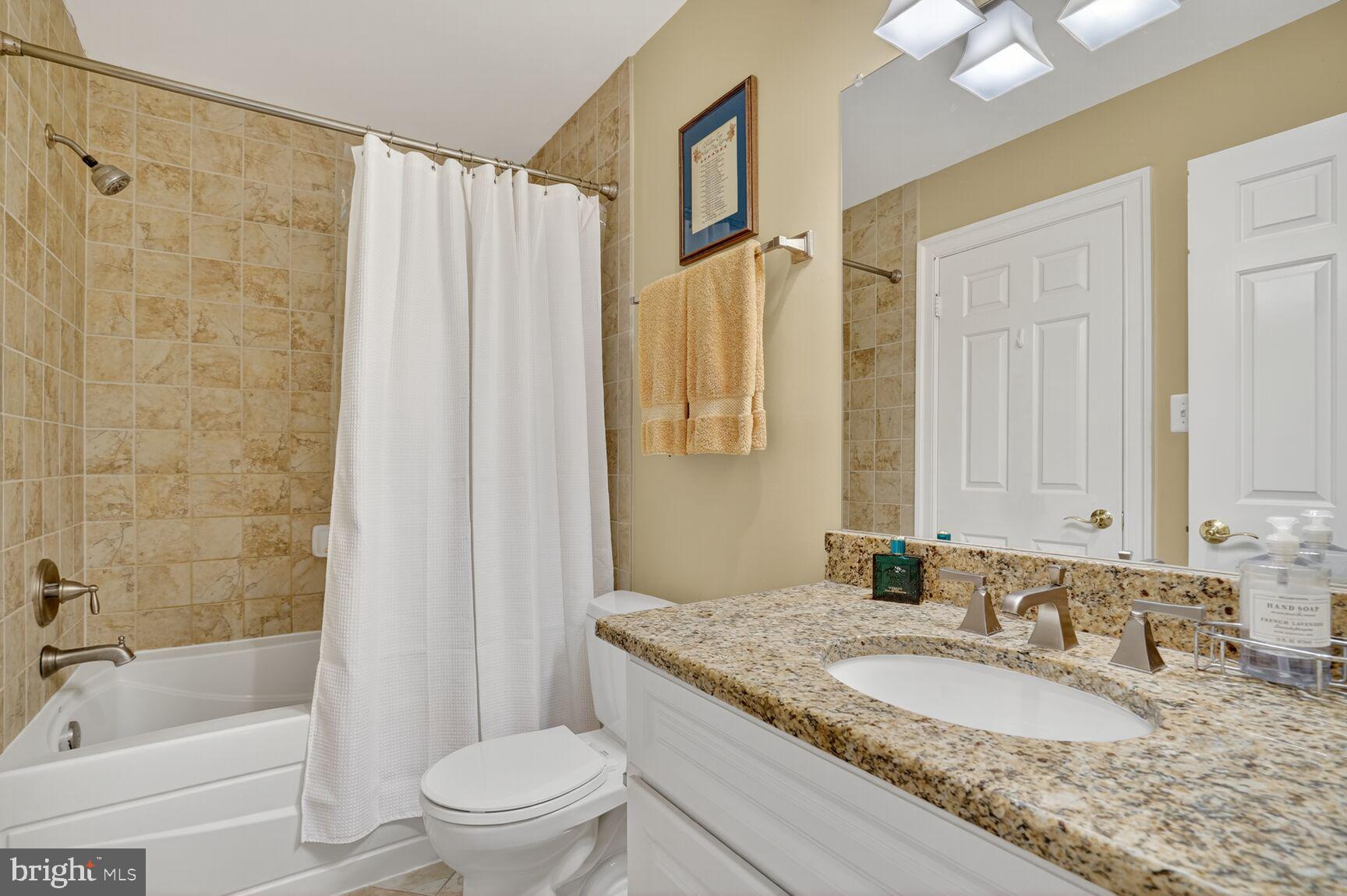 6705 Cedar View Court Clifton, VA 20124 - Photo 62 of 72 a bathroom with a granite countertop sink toilet and shower