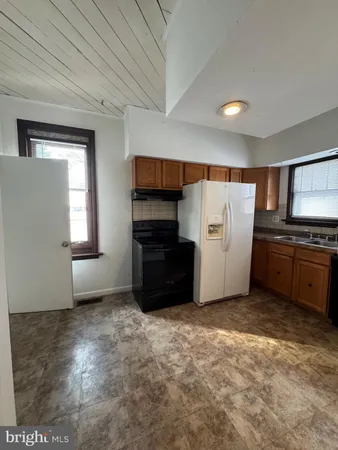 a view of kitchen with furniture and stainless steel appliances