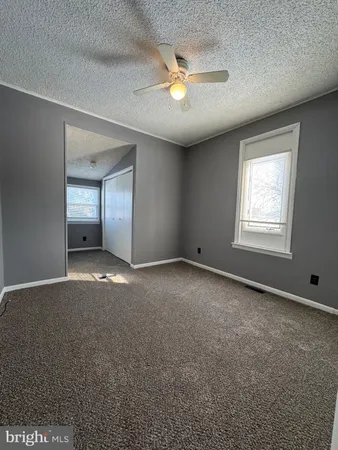 an empty room with a empty space and windows