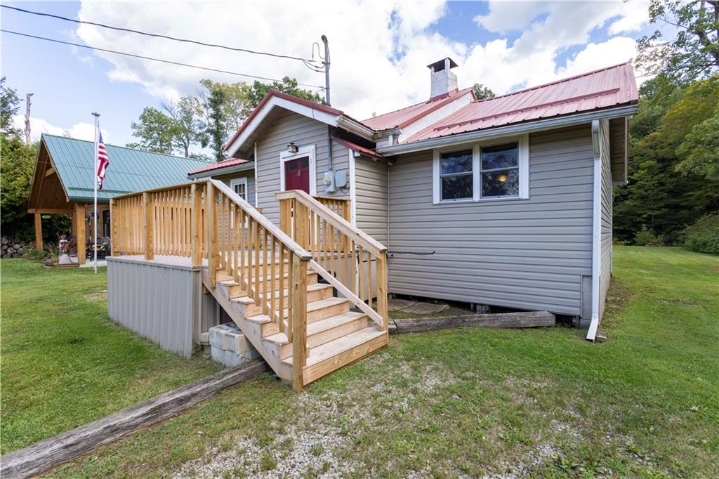 a view of a house with a yard and deck