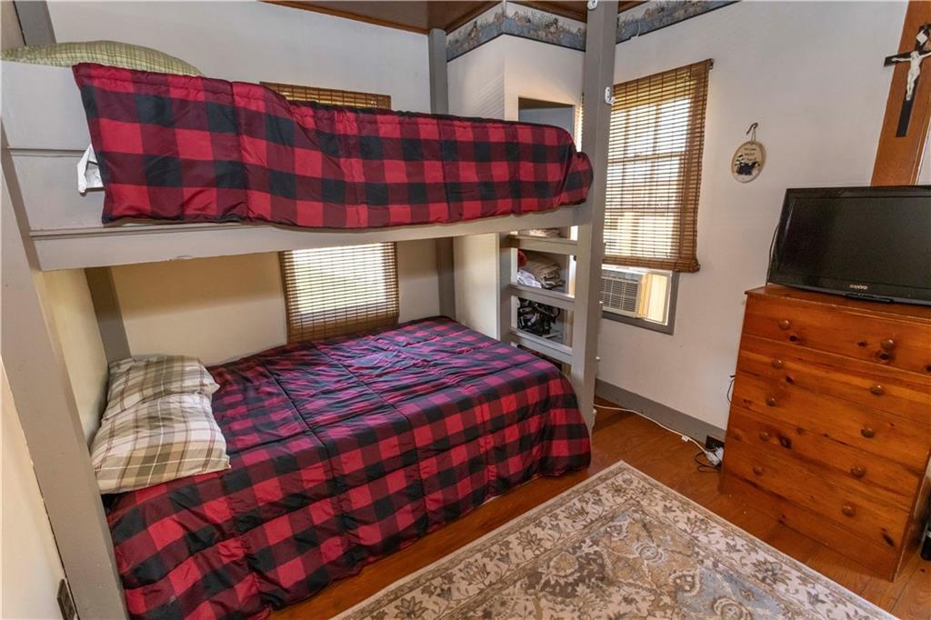 526 Nebo Road Champion, PA 15622 - Photo 20 of 30 a bedroom with a bed and wooden floor