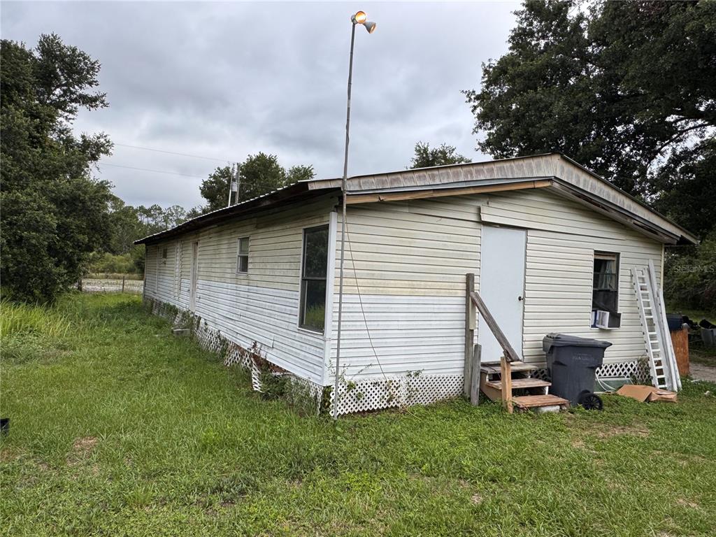 12315 Ranchland Trail Lakeland, FL 33809 - Photo 2 of 2 a backyard of a house with table and chairs