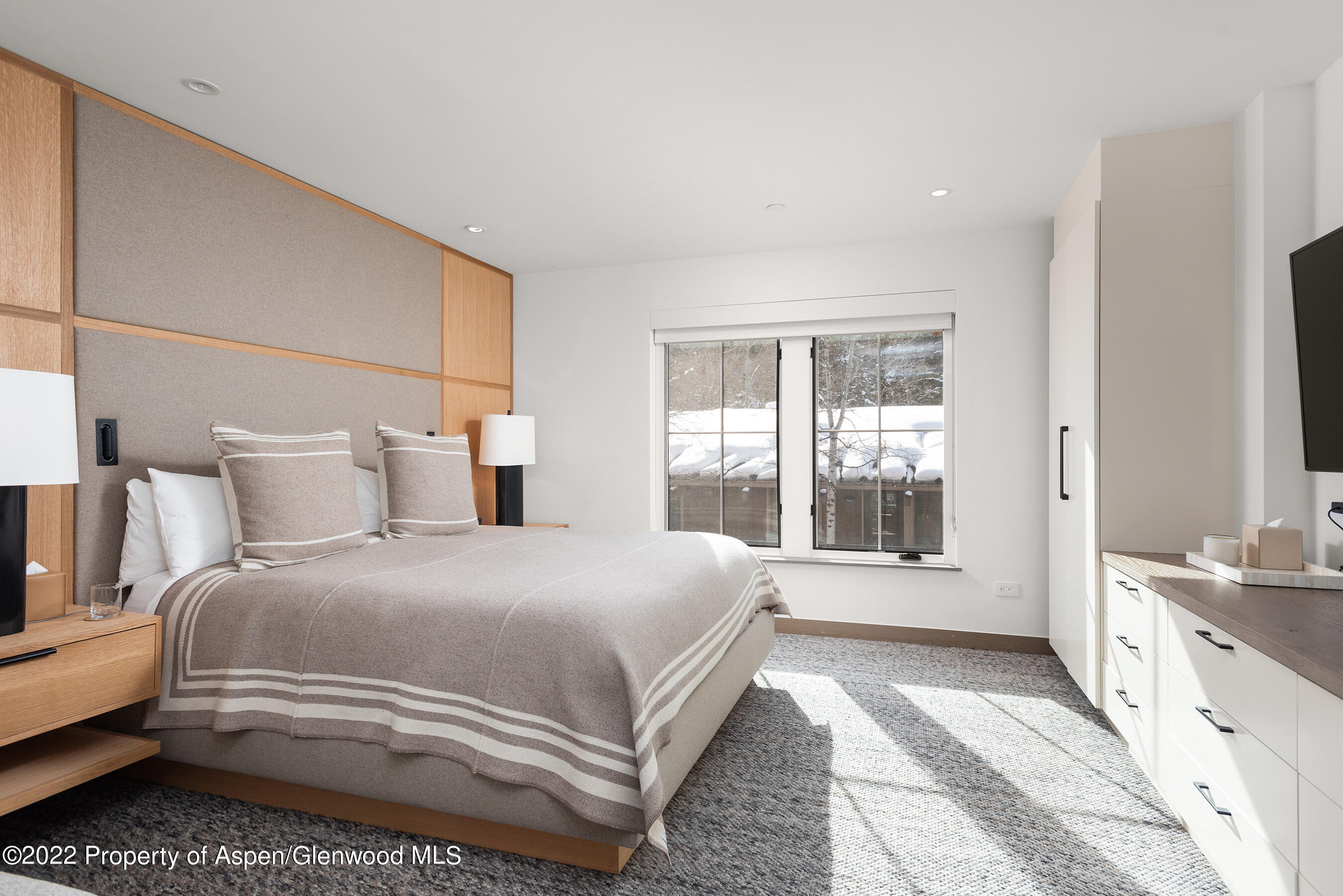 550 South Spring Street, Unit 392 Aspen, CO 81611 - Photo 10 of 41 a spacious bedroom with a bed and a large window