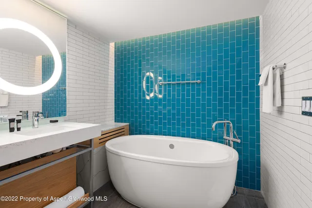 a bathroom with a toilet a sink and a mirror