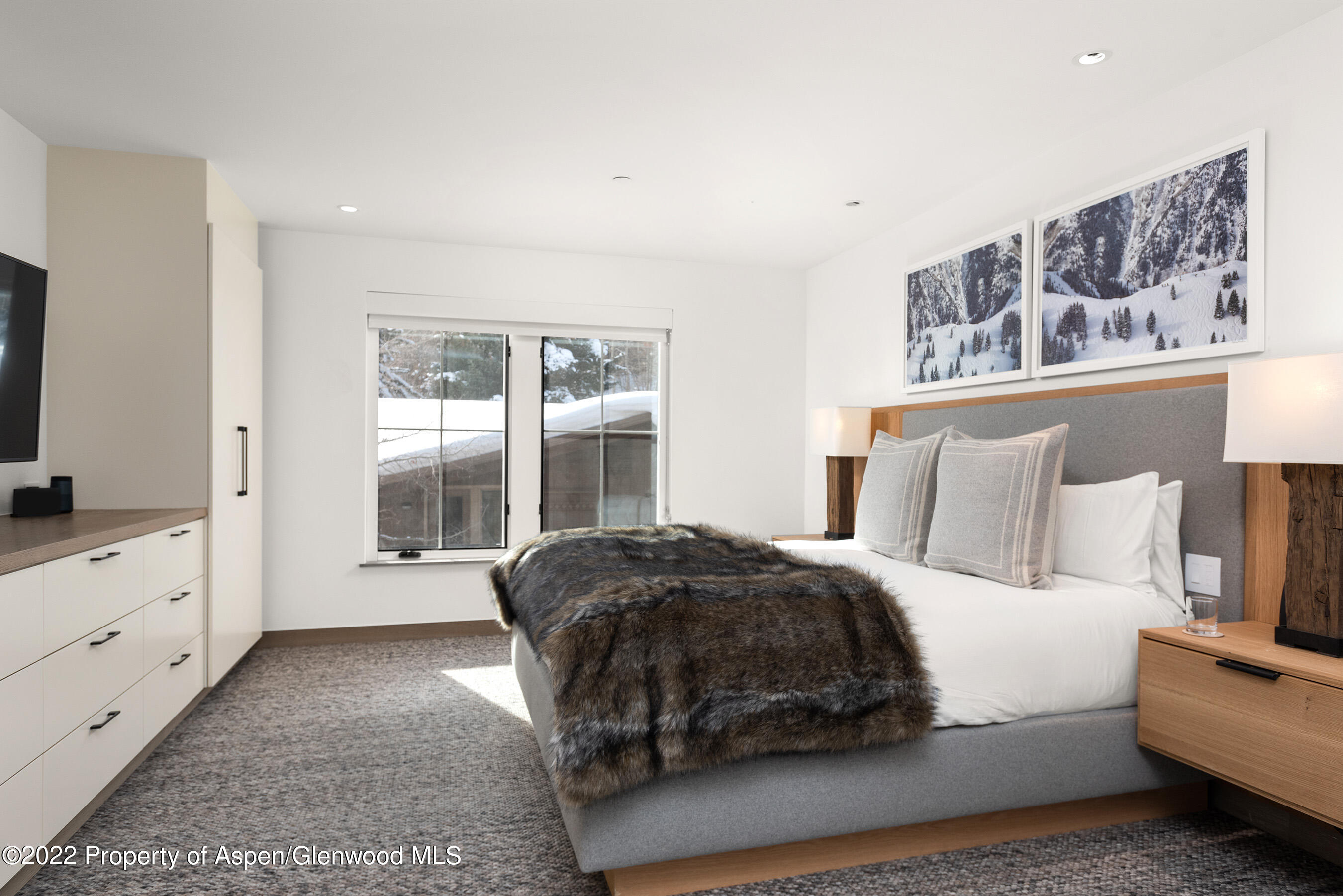 550 South Spring Street, Unit 392 Aspen, CO 81611 - Photo 16 of 41 a spacious bedroom with a bed a couch and large window