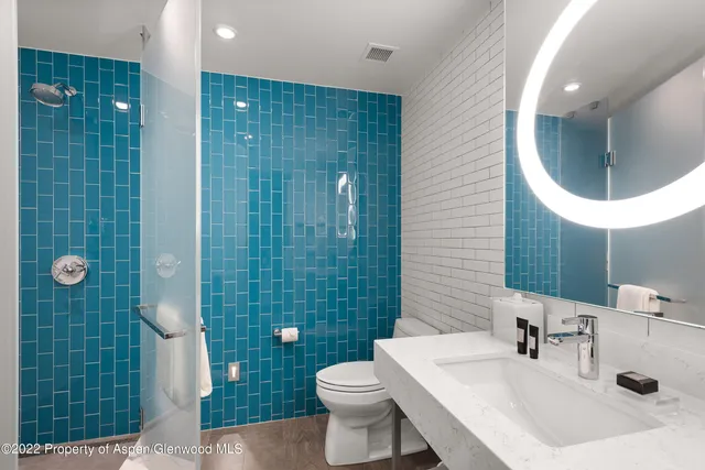 a bedroom with two beds and a large window