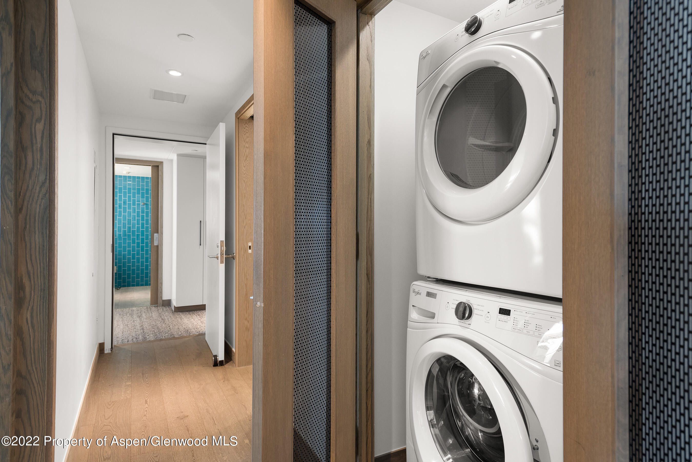 550 South Spring Street, Unit 392 Aspen, CO 81611 - Photo 22 of 41 a view of a hallway with washer and dryer
