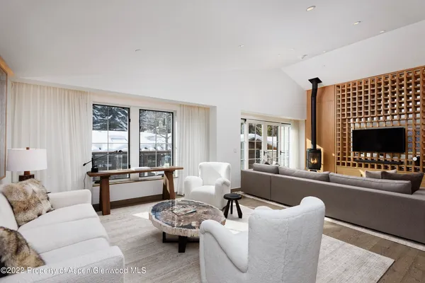 a living room with furniture and floor to ceiling window