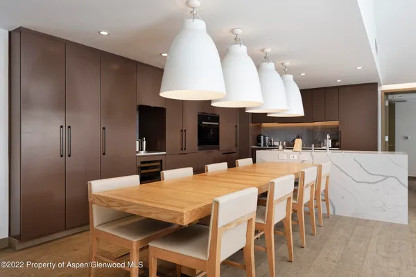 a large kitchen with a table and chairs