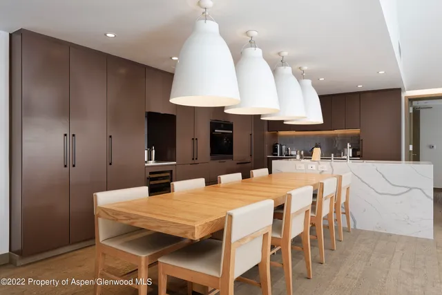 a large kitchen with a table and chairs
