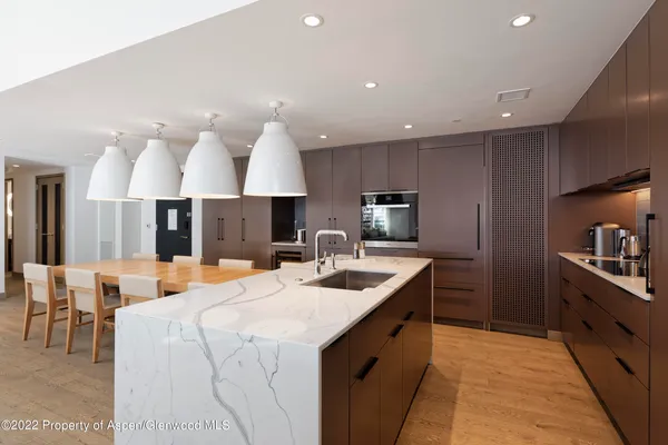 a kitchen with a sink appliances and a large window