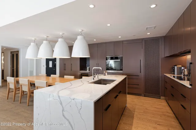 a kitchen with a sink appliances and a large window